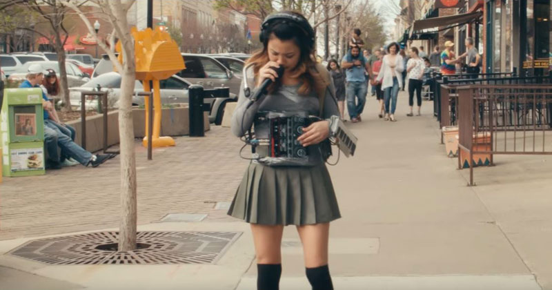 One-Woman Band Creates Entire Song While Casually Strolling Down the Street