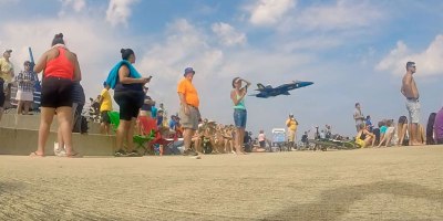 Blue Angel Sneaks Behind Crowd For Surprise Low Pass Flyby