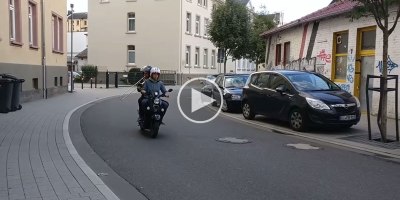 This Guy Playing Trombone on the Back of a Scooter Sounds Like He's Going 200 mph