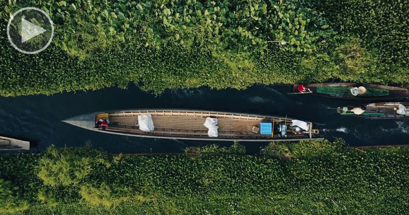 Drone Captures Boat Traffic Through Floating Gardens and Villages from Above