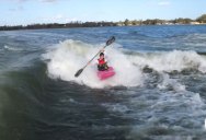 Just a Guy Kayaking Behind Two Wakeboard Boats