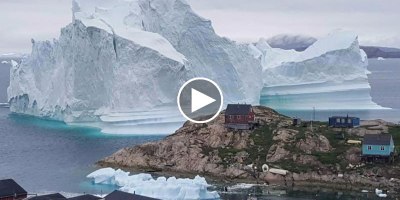 Incredible Timelapse Shows 300 ft Tall Iceberg Drift Perilously Past Small Village
