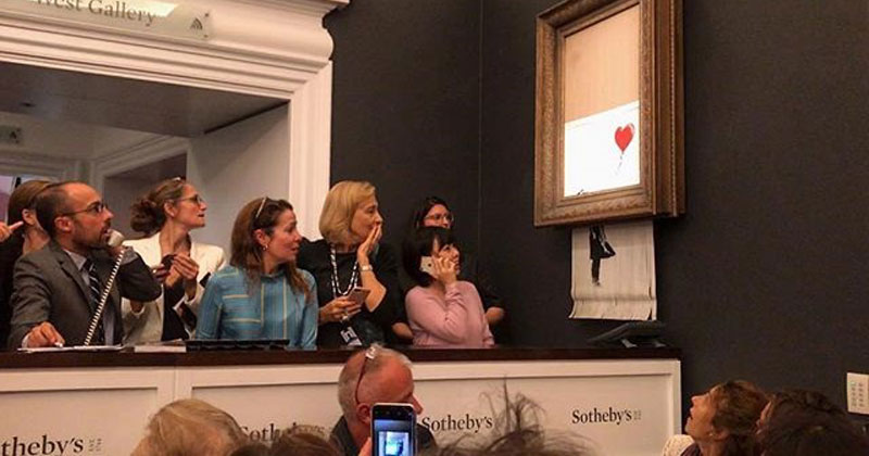 banksy shredder painting at auction Banksy Artwork Self Destructs after Selling for $1 Million at Auction