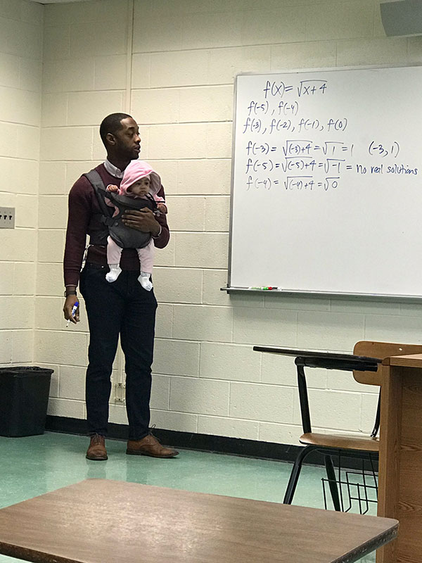 teacher holds students baby during lecture 4 Teacher Goes Viral After Holding Students Baby So They Could Take Notes