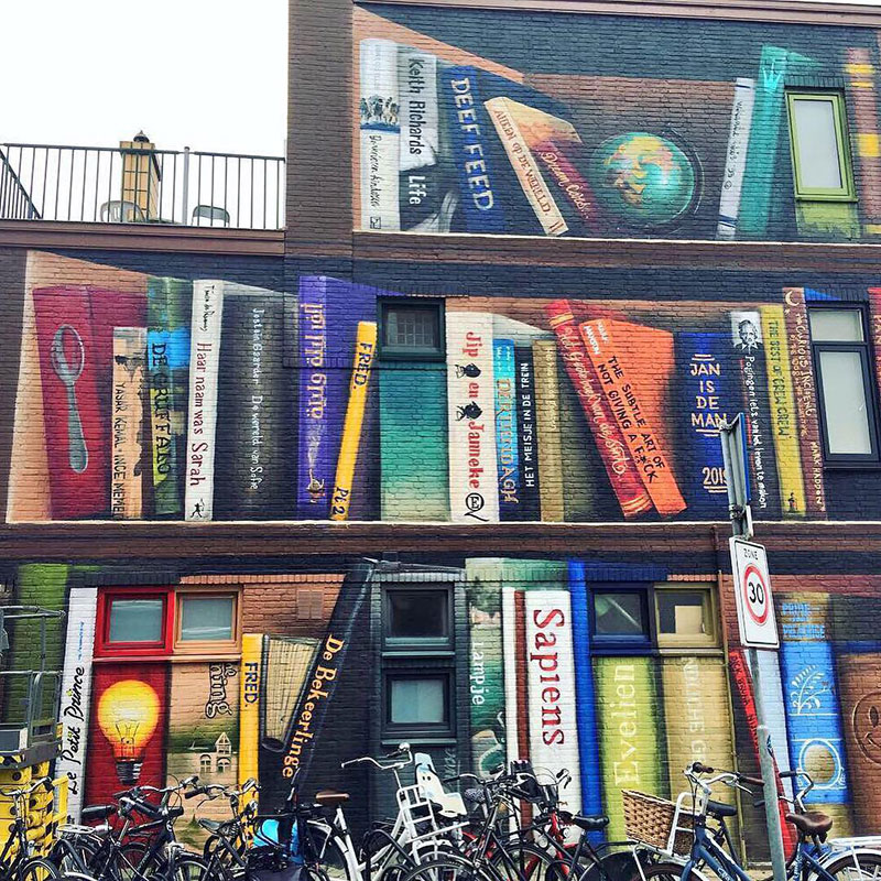 giant 3d bookshelf street art by jan is de man and deef feed 8 Dutch Artists Paint Giant 3D Bookshelf of Neighborhoods Favorite Books