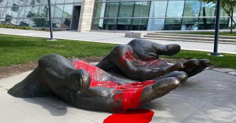 Red Paint Completely Changed This 'Serve and Protect' Sculpture During the Protests
