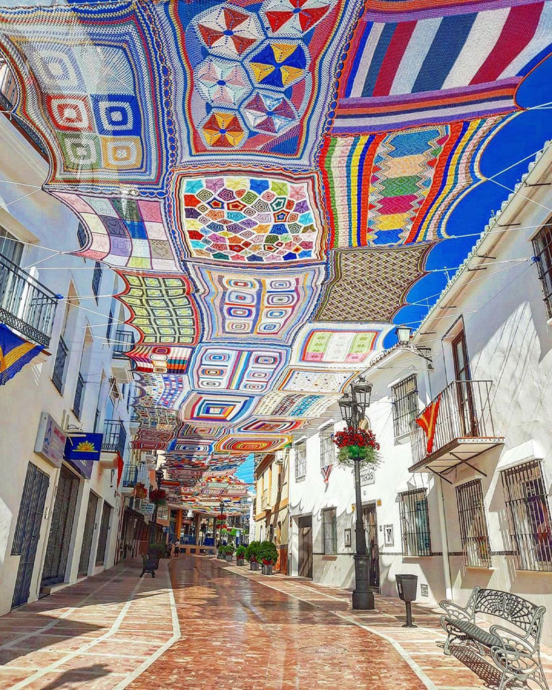 A vast patchwork of crocheted canopies provides beautiful shade in