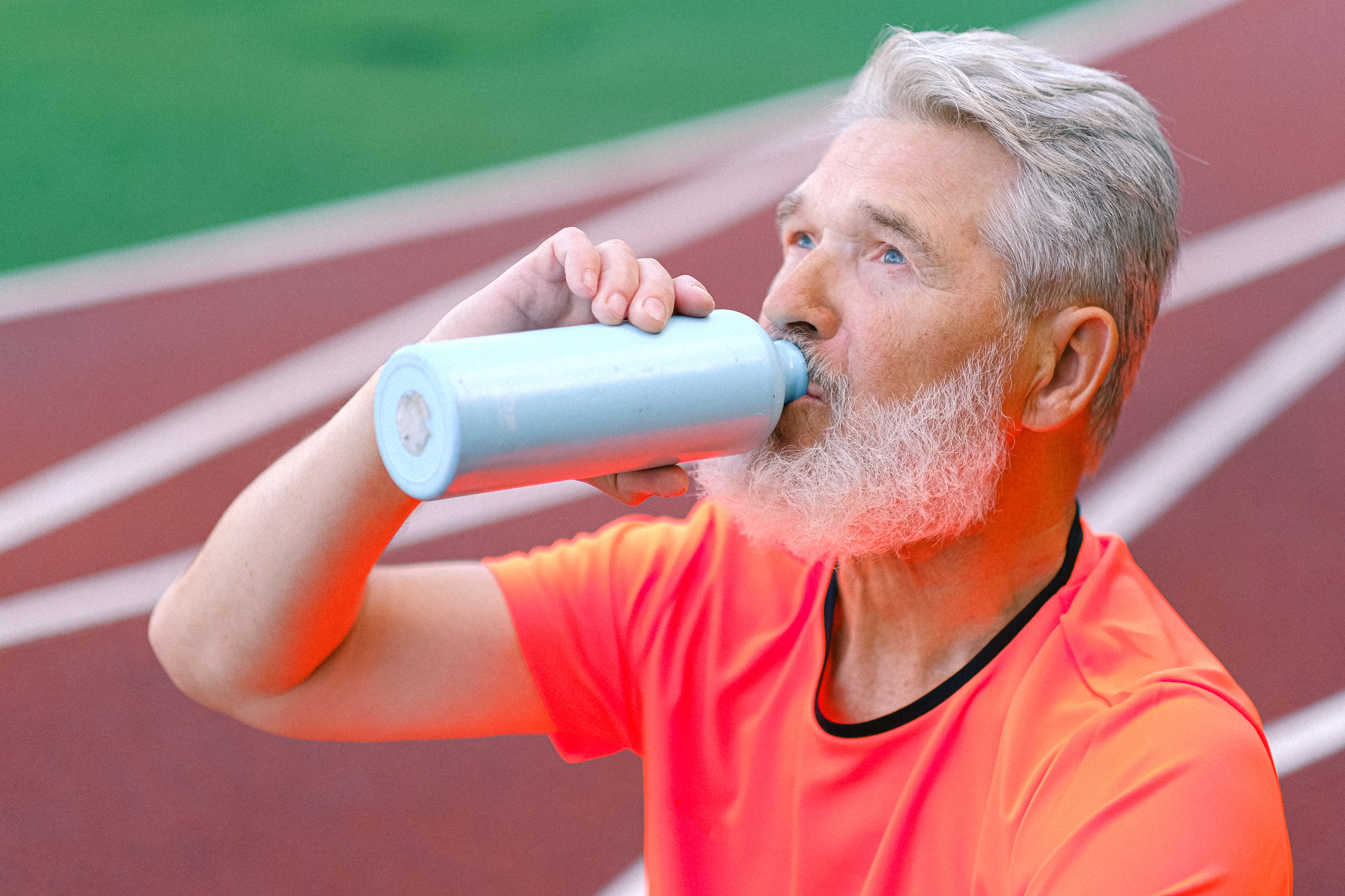 Runner drinking water Featured Image How Do You Know if You’re Drinking Too Much or Not Enough Water?