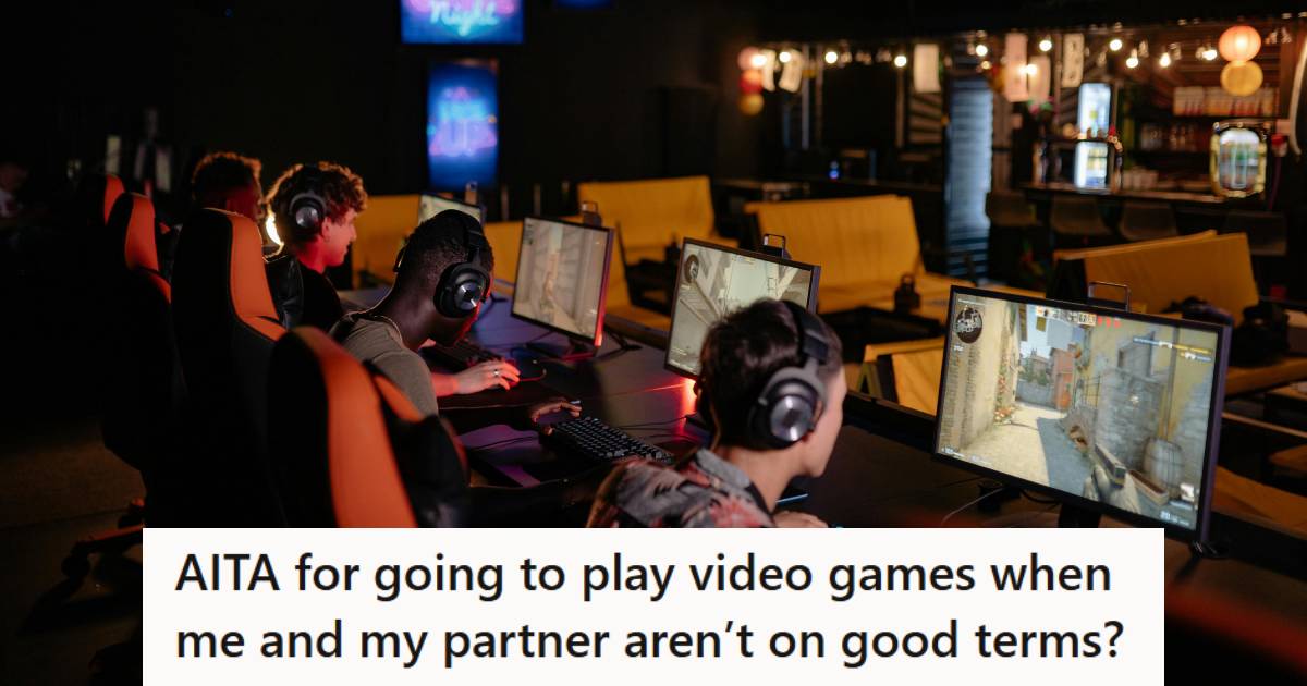 men in a dark room playing computer video games