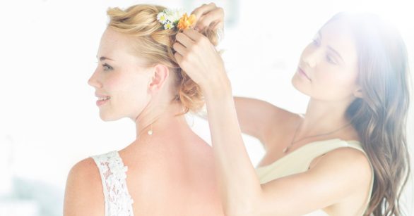 maid of honor helping bride with her hair