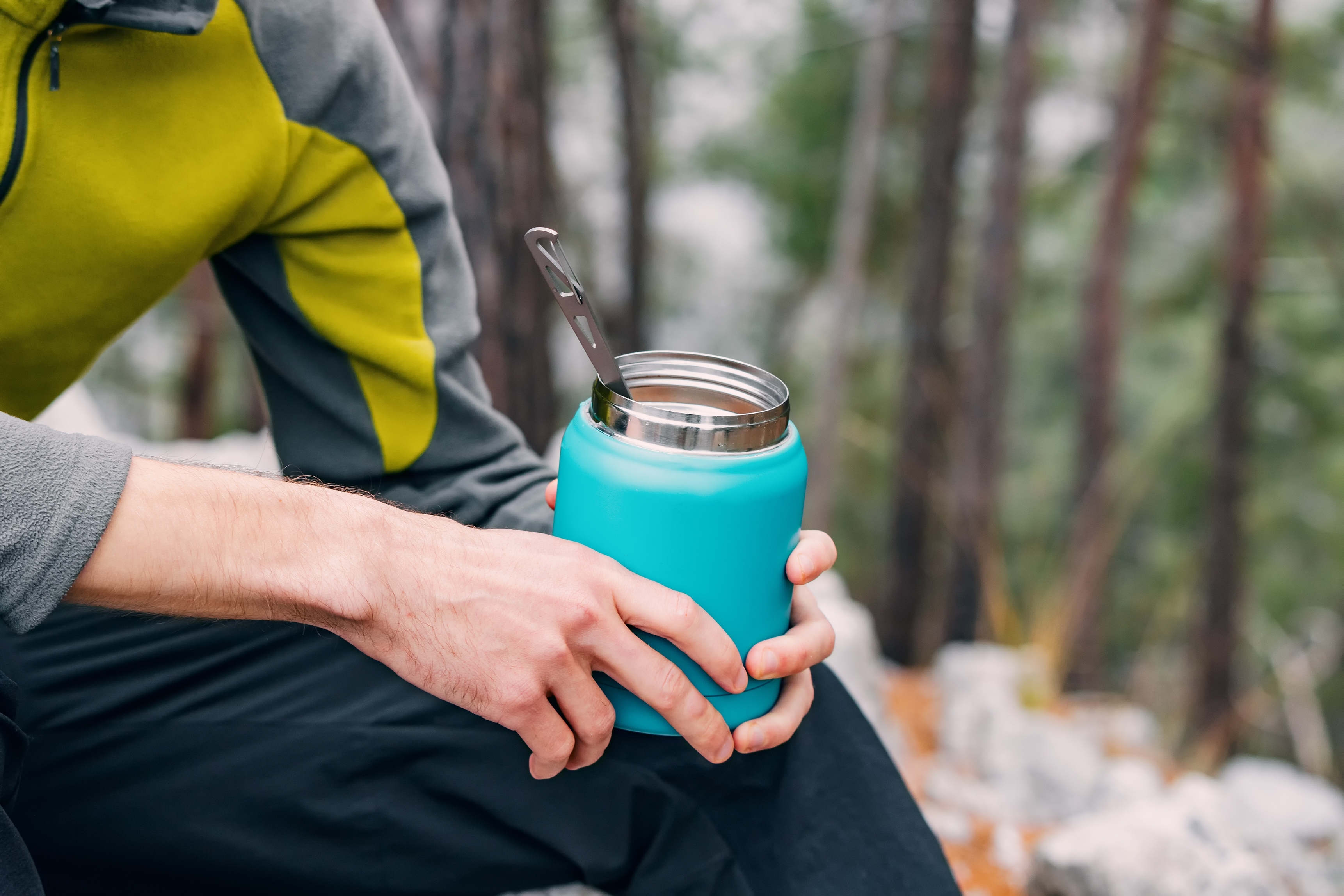 man holding coffee thermos