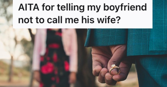 A man's hand holding an engagement ring behind his back