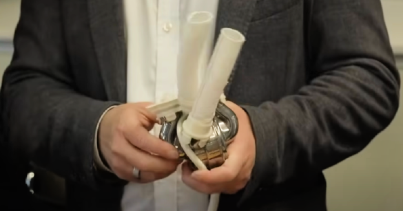 Inventor holding titanium heart