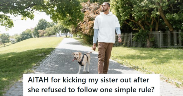 Man walking his yellow Labrador Retriever down the road