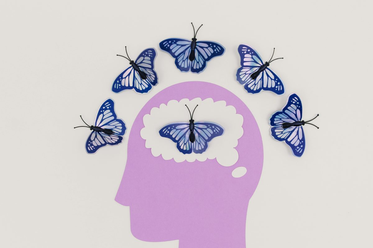 An illustration of a brain with blue butterflies