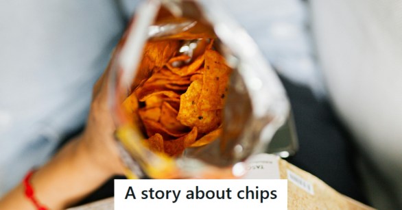 Person eating a bag of chips on their lap.