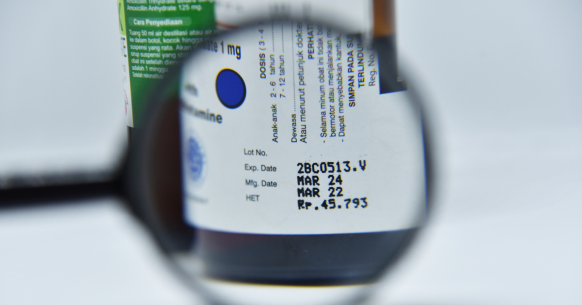 Is It Dangerous To Take Medications That Have Expired? The FDA Warns About The Potential Risks. magnifying glass on medicine expiration date