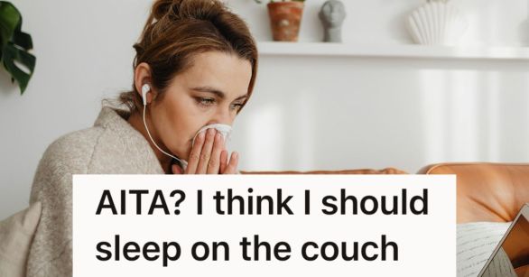 Woman blows her nose on a couch