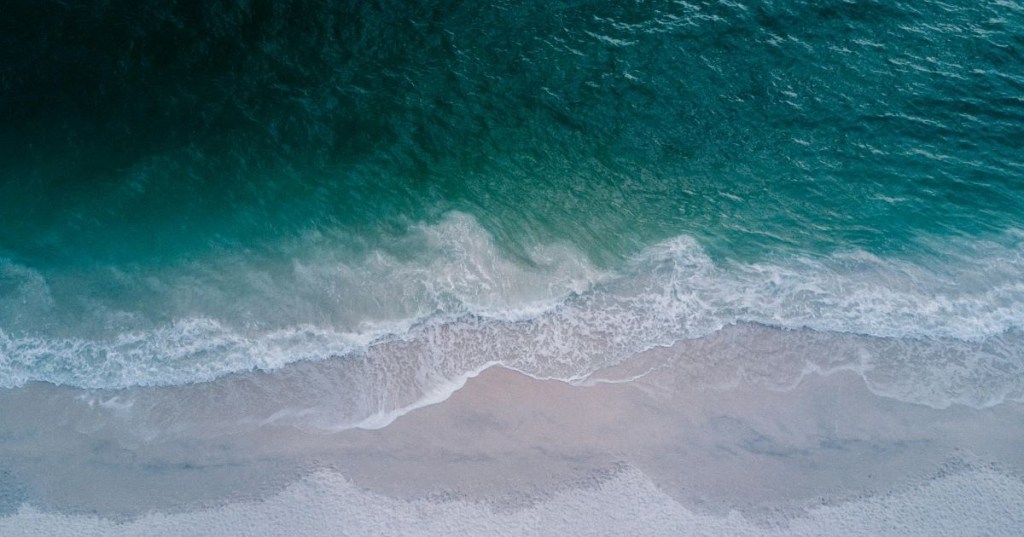 Blue-green ocean waters lapping the shore