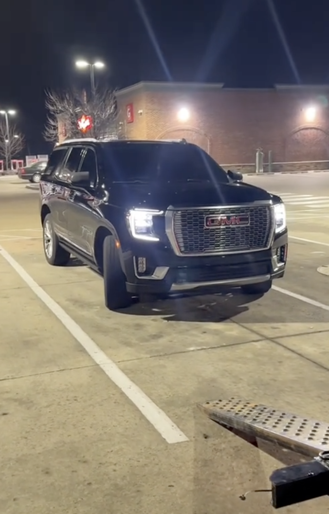 a black SUV in a parking lot