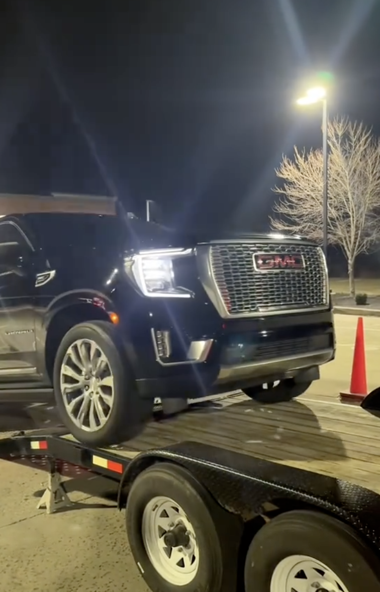 a vehicle being loaded on a truck bed