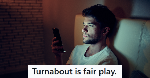 man sits in bed looking at phone at night