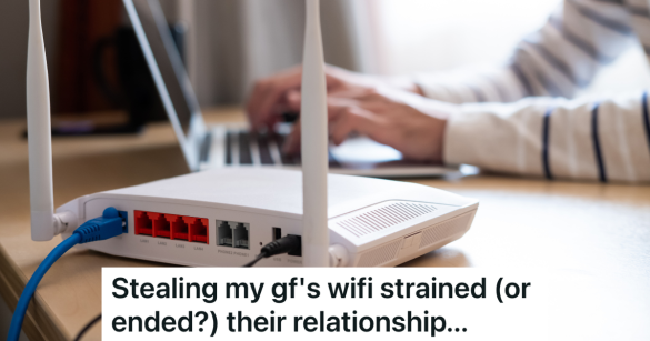 woman types on laptop next to wifi router