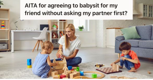 Woman babysitting and playing with 2 young children on the floor