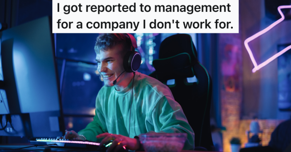 smiling man sits in a dark room playing video games