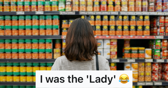 woman looks at wall of canned good at a grocery store