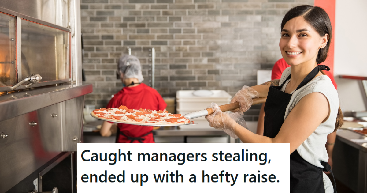 female employee pulling pizza from oven