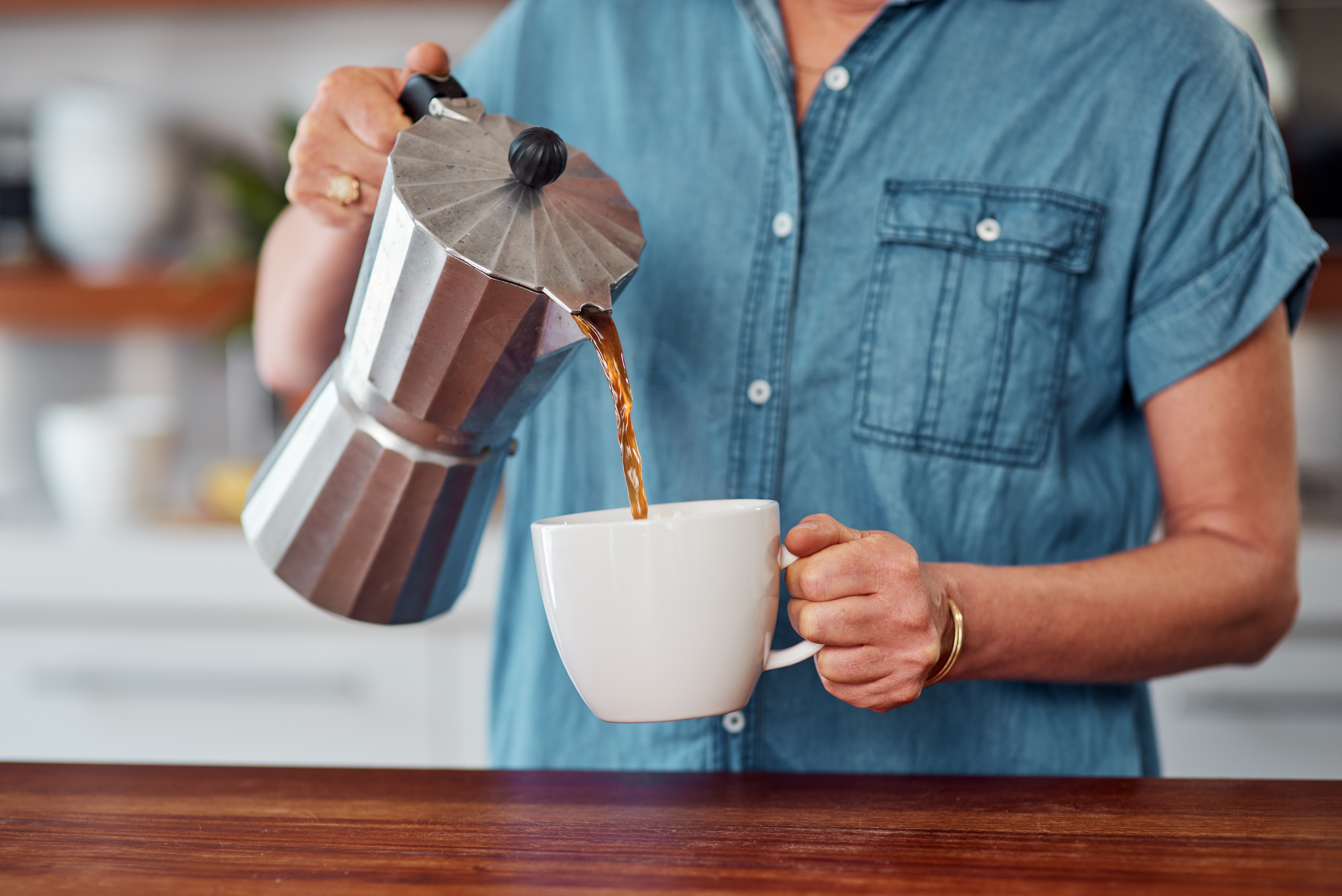 woman pouring coffee from french press