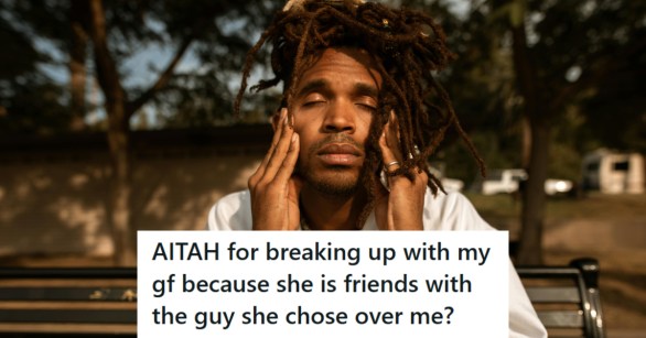 A stressed out man sitting on a park bench