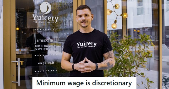 Man standing out front of a cafe he owns