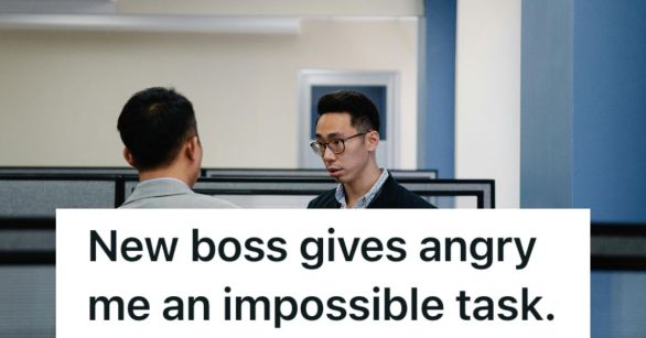 Two male staff talk between cubicles.