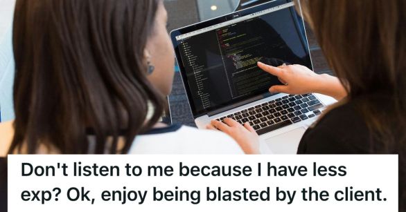 Two women reading computer code