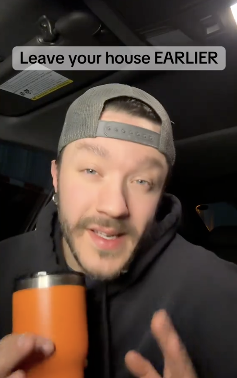 man holding a candle and talking