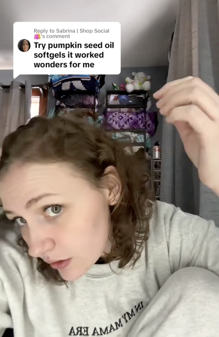 woman pulling on strands of her hair