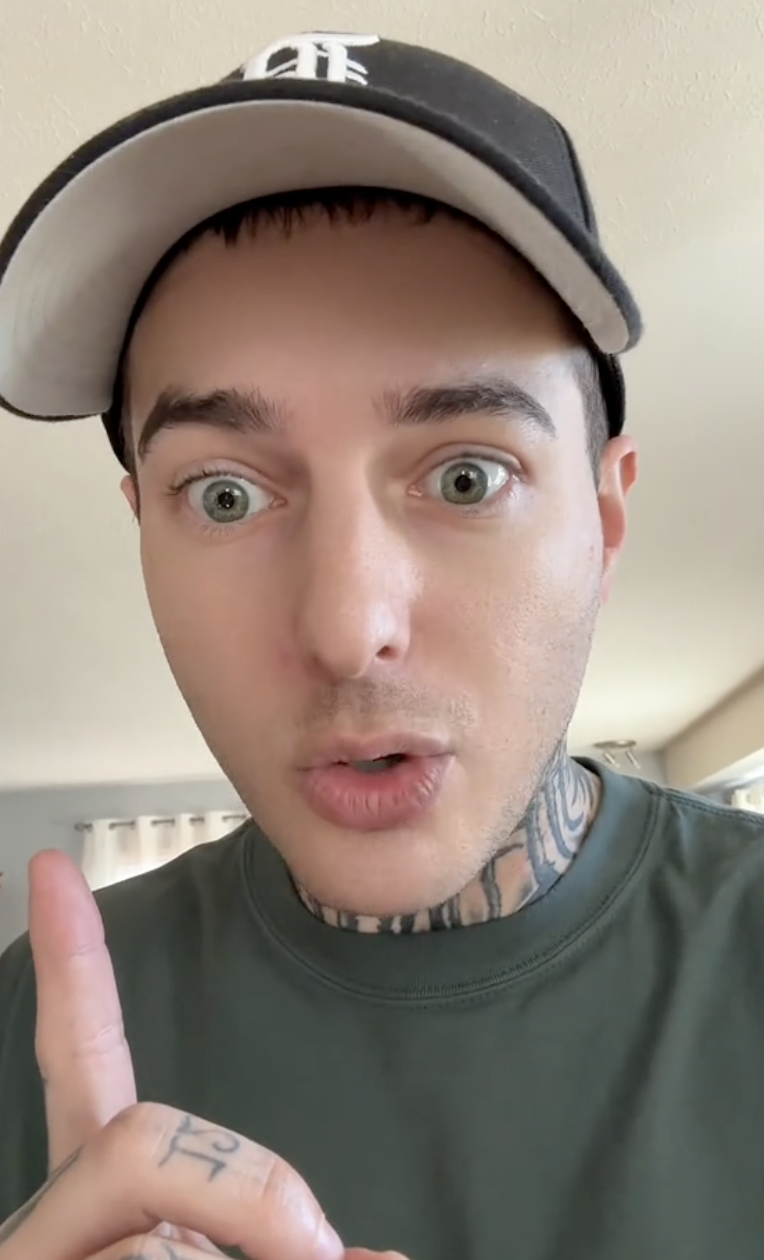 man pointing his finger upward