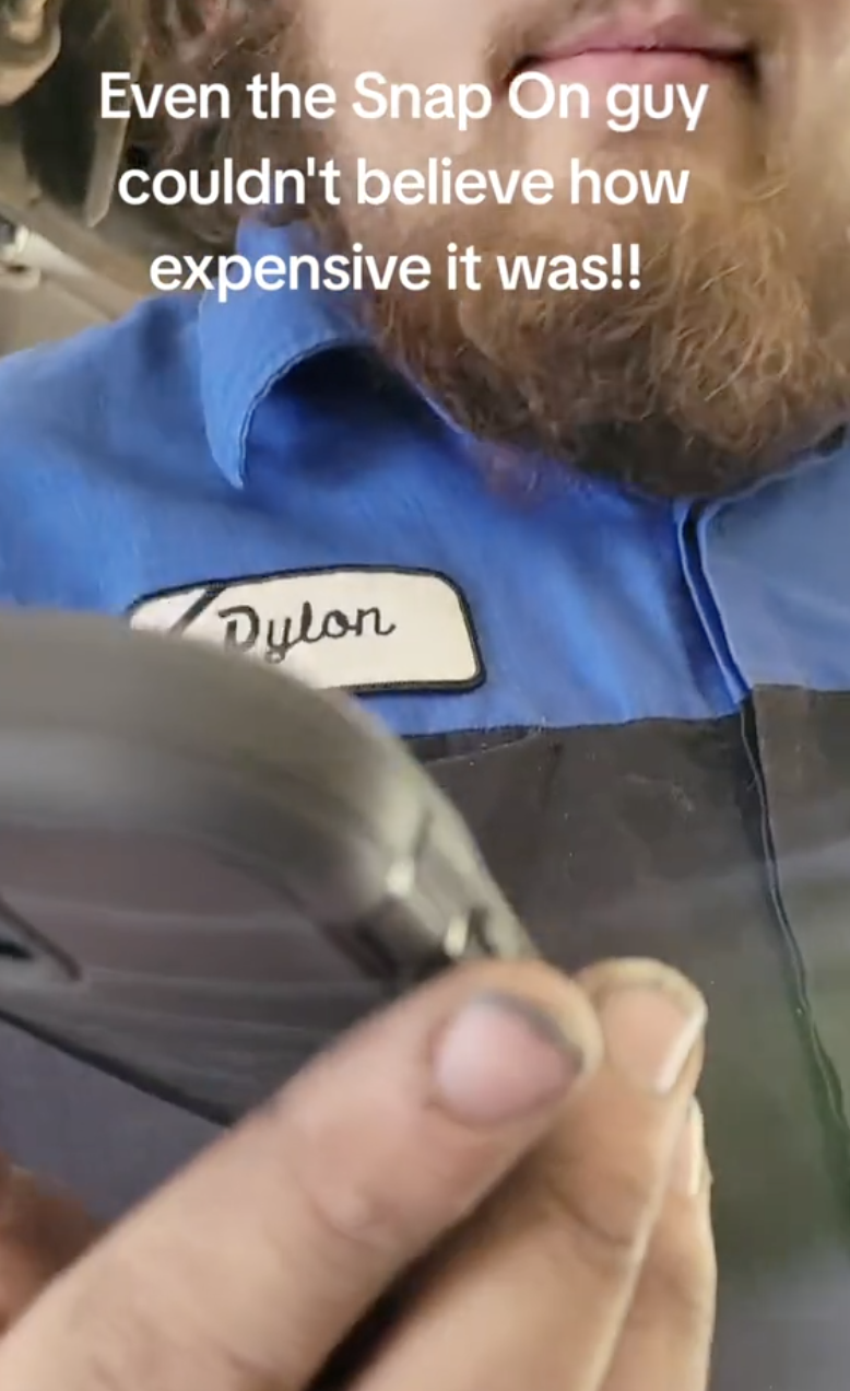 mechanic looking at his phone