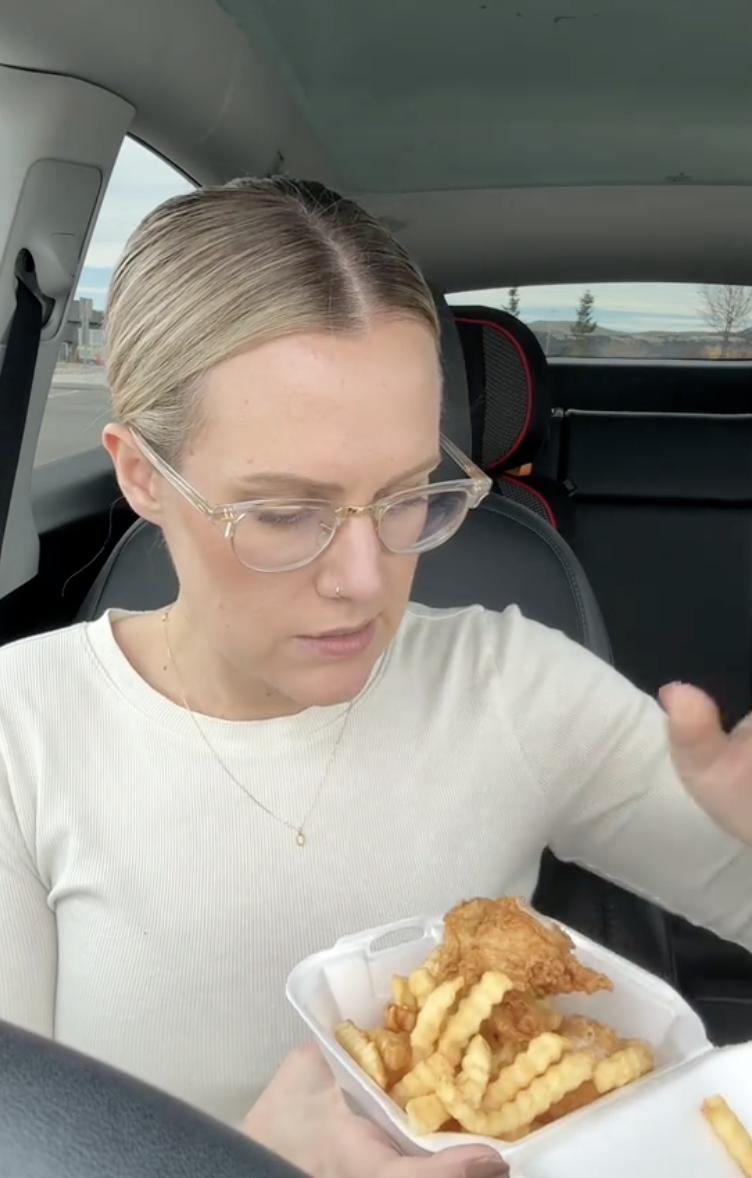 woman in a drive-thru with food