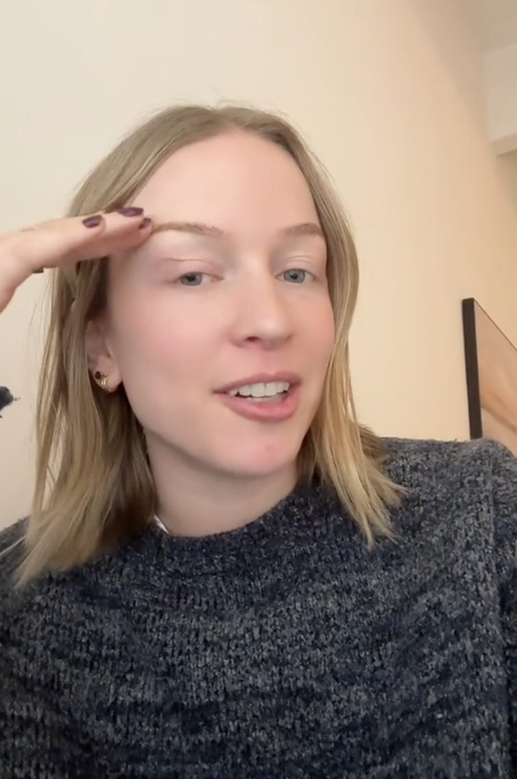 woman in grey sweater talking