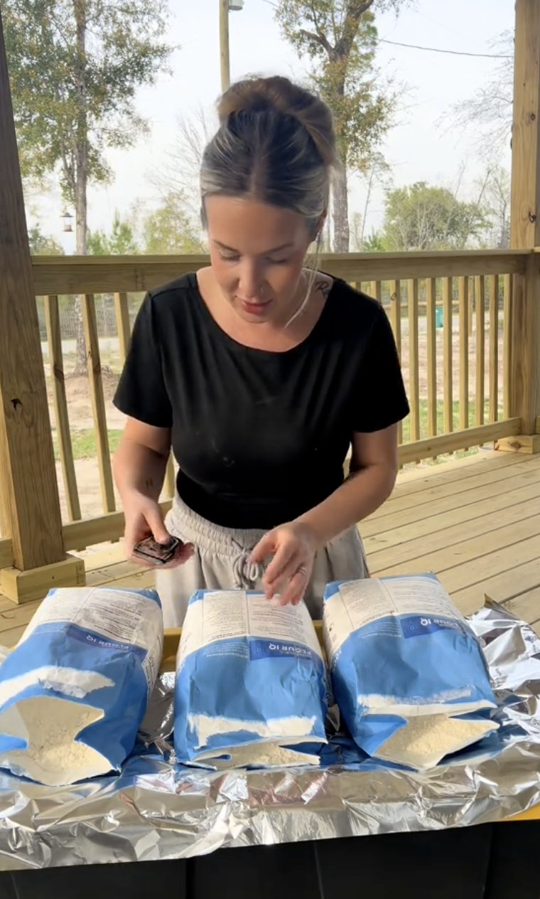 woman with three bags of flour