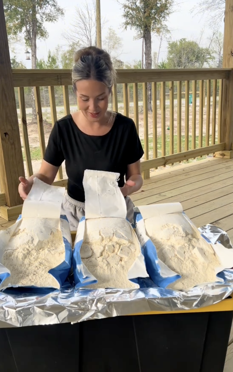 women on a porch with bags of flour