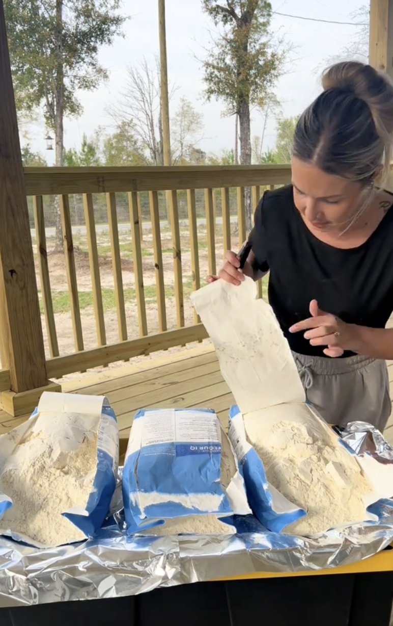 woman showing bags of flour