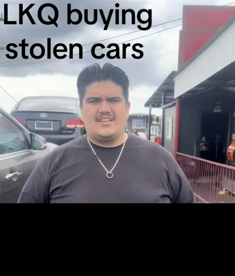 man standing outside a car shop