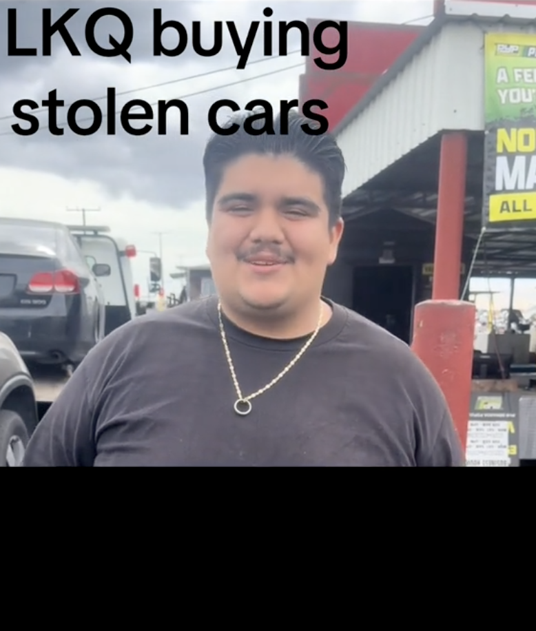 man outside a used car shop