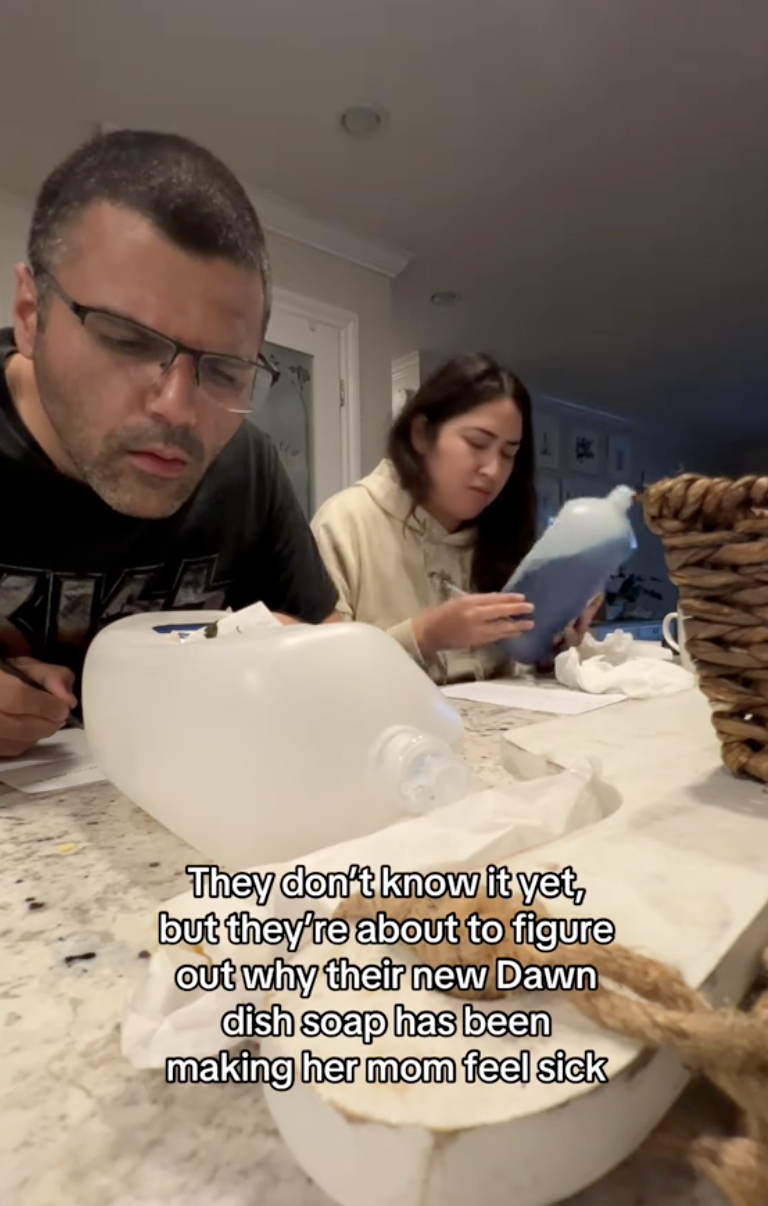people inspecting the ingredients on a bottle of dawn