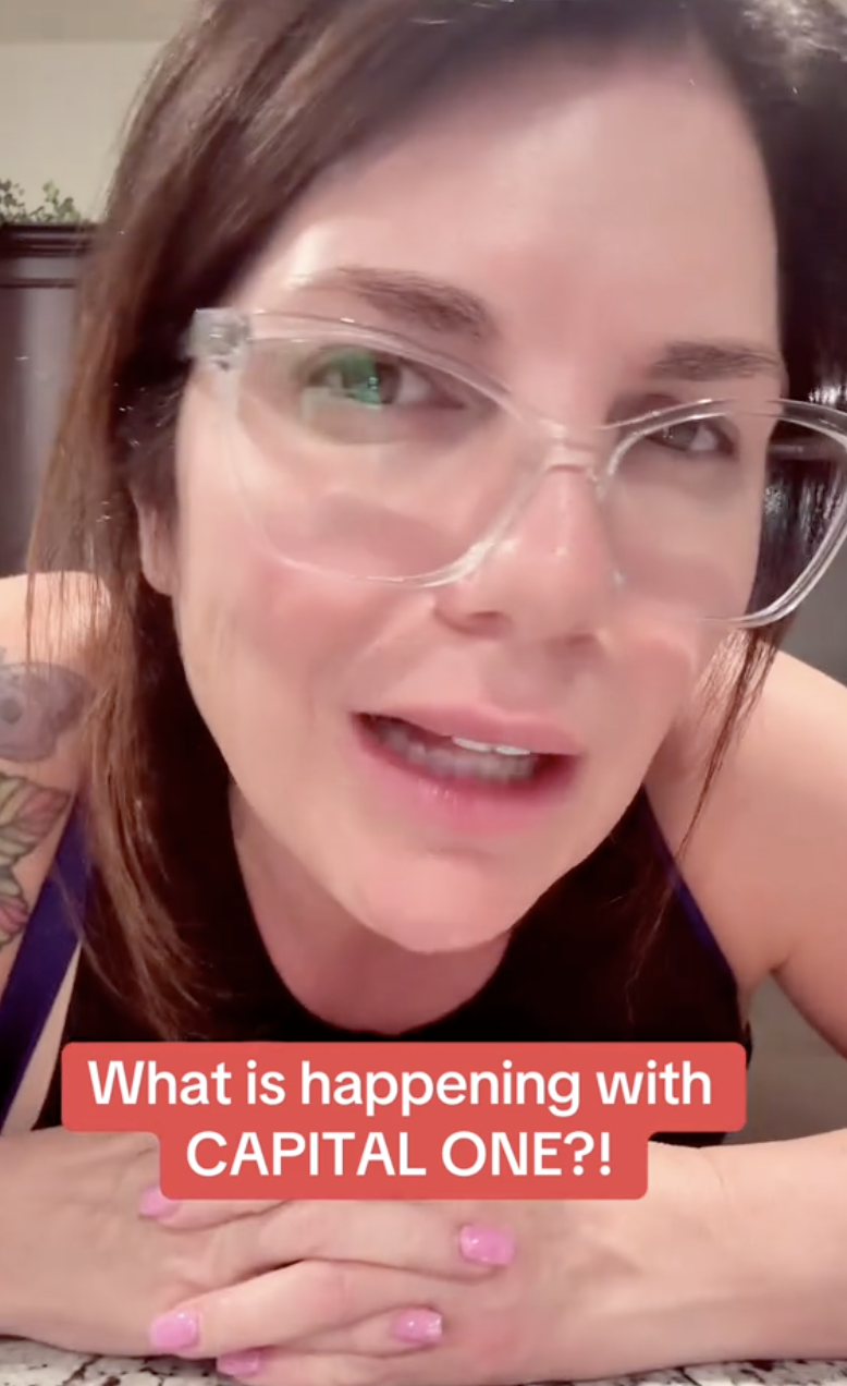 woman talking to a camera while sitting at a table