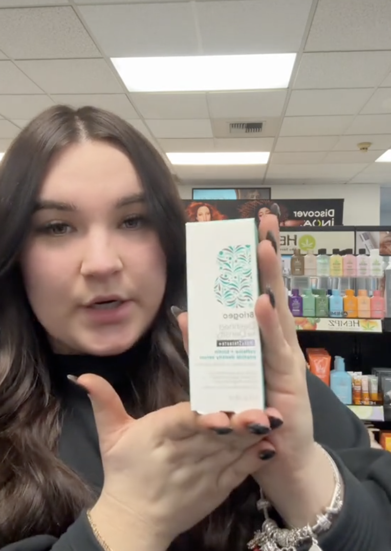 woman showing a hair care product